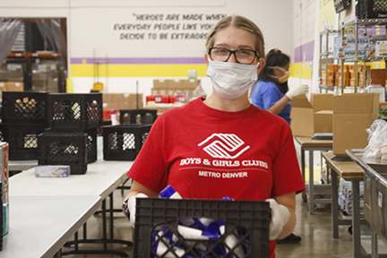 Boys girls club volunteer at warehouse