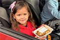 Donation eCard: Little girl in a car with food